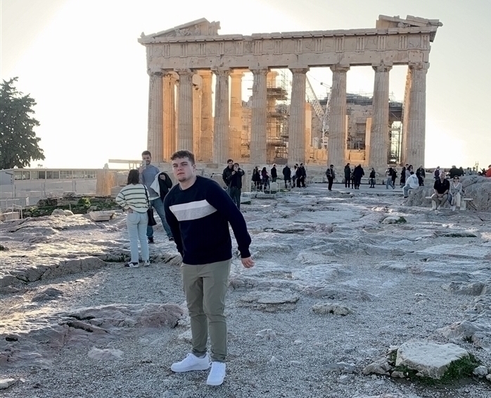 James in front of classic Greek architecture