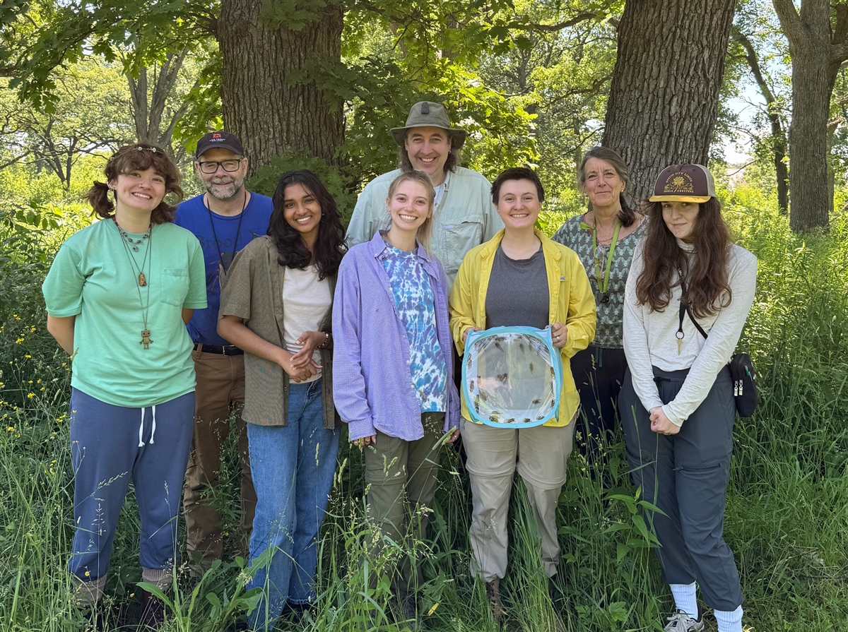 students in the field with menke