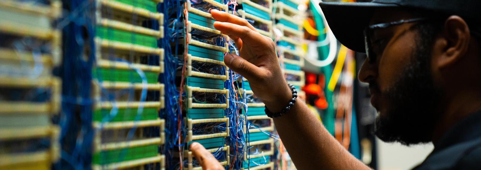 student inspecting a computer system