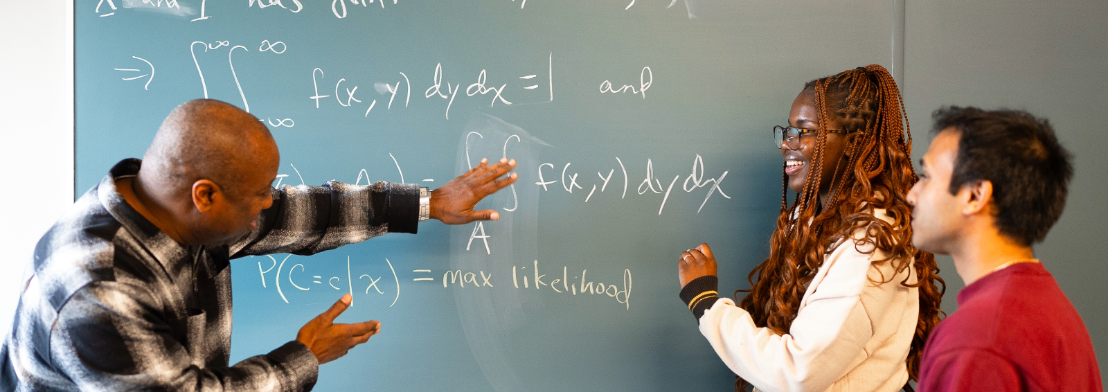 students and professor at chalk board