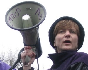 Kim Cook with a bullhorn leading a rally