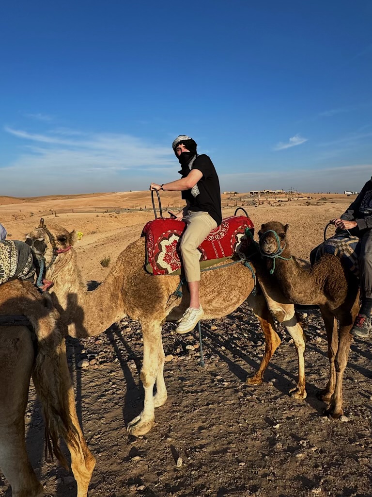 Ethan riding a camel in Marrakech