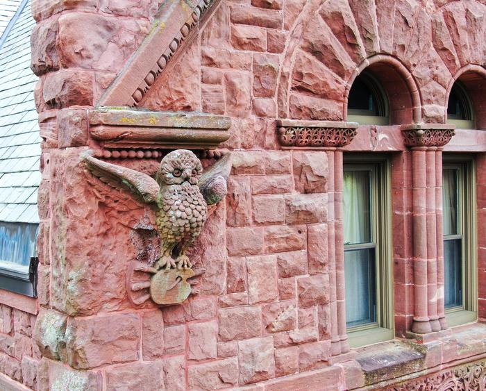 owl detail on red brick building