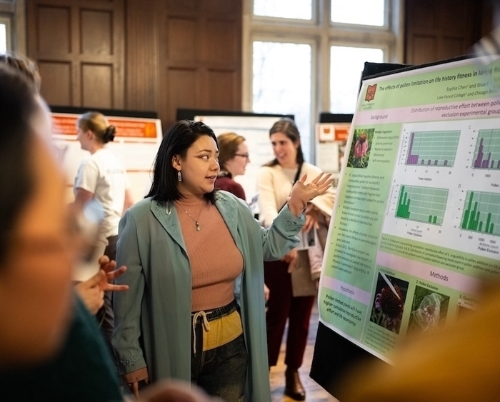 student explaining research at science poster session 