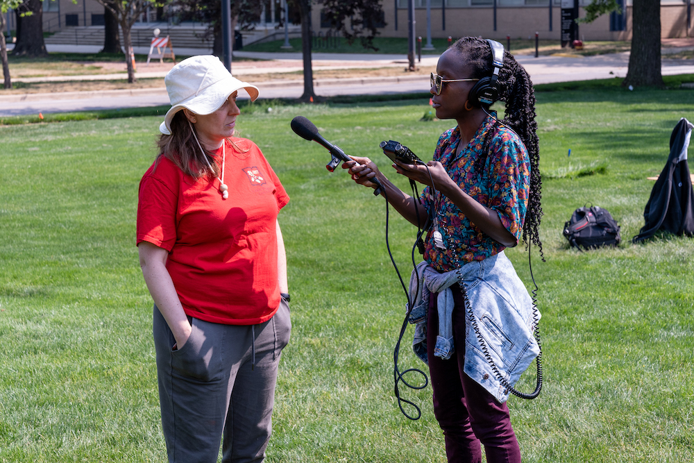 Radio reporter interviewing professor at dig site