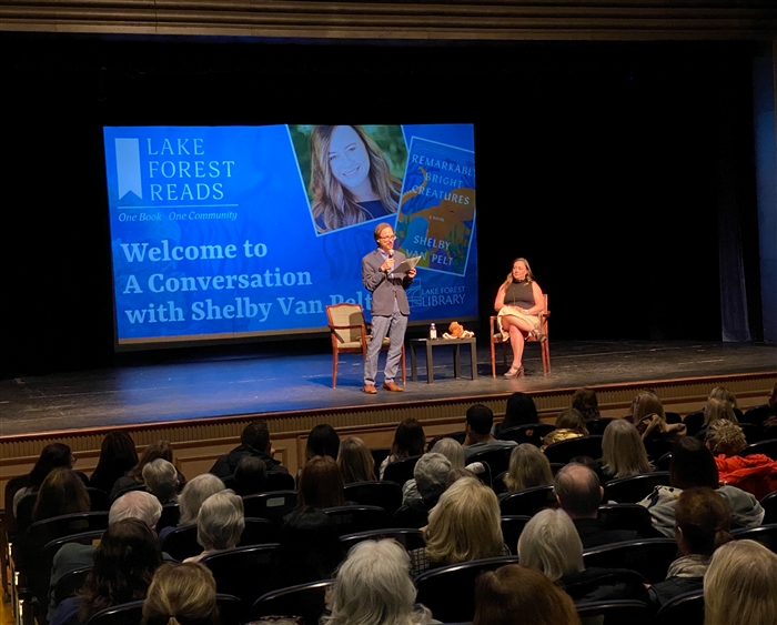 author and interviewer on stage