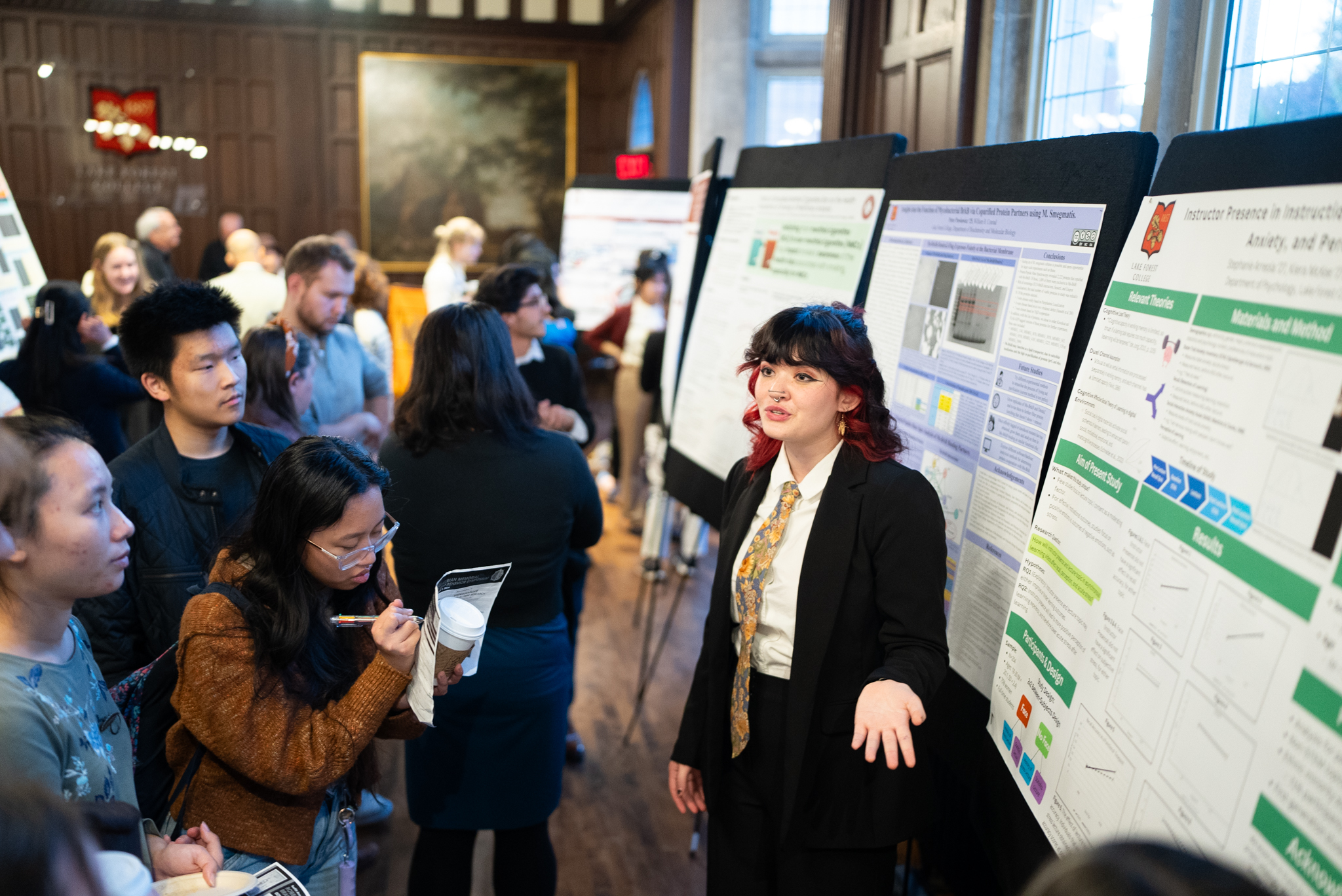 Student presenting poster to crowd