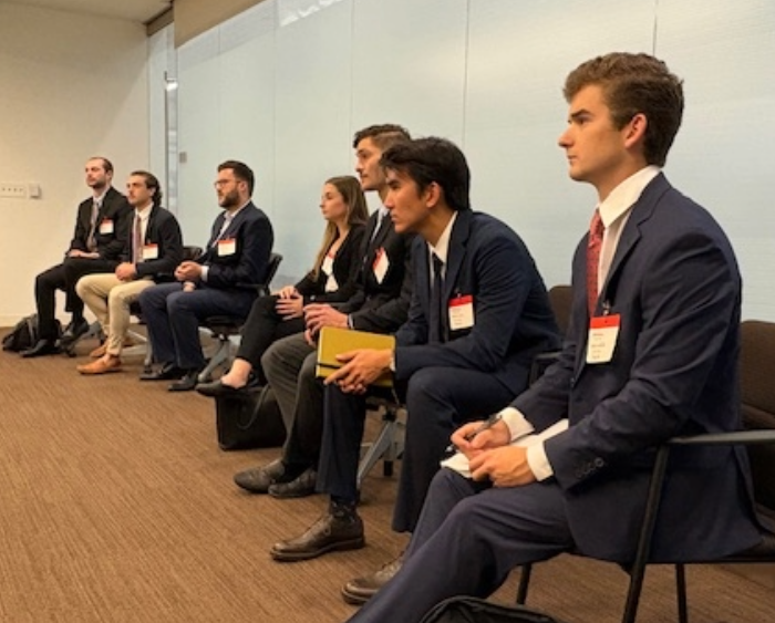 students listen in on a finance meeting