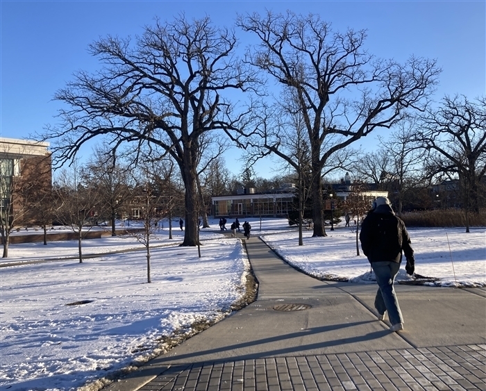 students walking across campus 