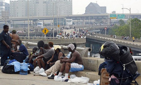 Hurricane Katrina refugees take shelter from floodwaters on a highway overpass in New Orleans 01 September, 2005. Up to 300,000 survivors from the hurricane may still need to evacuated from disaster zones in Louisiana, Governor Kathleen Blanco said Thursday.   AFP PHOTO/JAMES NIELSEN  (Photo credit should read JAMES NIELSEN/AFP/Getty Images) ORG XMIT: DCA60