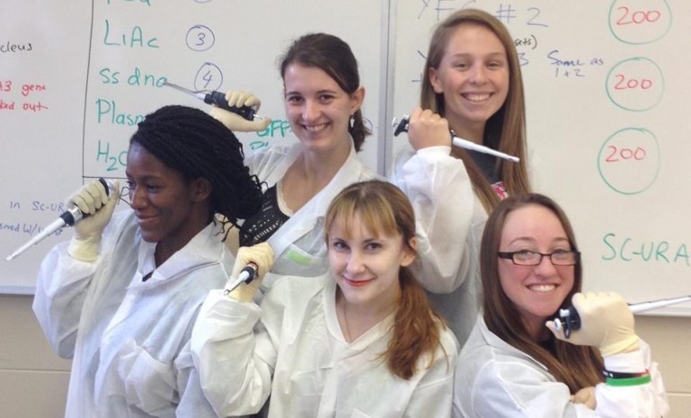 Neuroscience students posing with pipettes