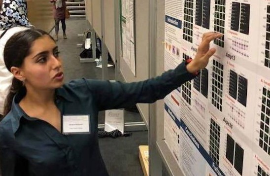 A Neuroscience student presents a research poster