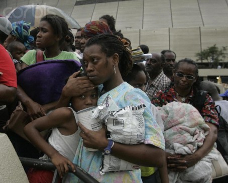 01 Sep 2005, New Orleans, Louisiana, USA --- Dianne Wallace (L),  Alexis Fisher, 14,  Dejon Fisher, 8, and her mother Cavel Fisher Clay, 33, got a little unnerved as they waited in a hostile line to get onto busses to the Houston Astrodome on Thursday, September 1, 2005, days after Hurricane Katrina flooded New Orleans.  --- Image by © Michael Ainsworth/Dallas Morning News/Corbis